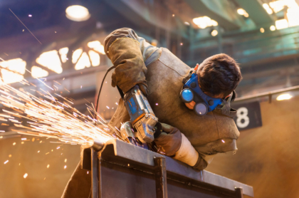 A young man welding with protective goggles. (Fotolia/TNS)